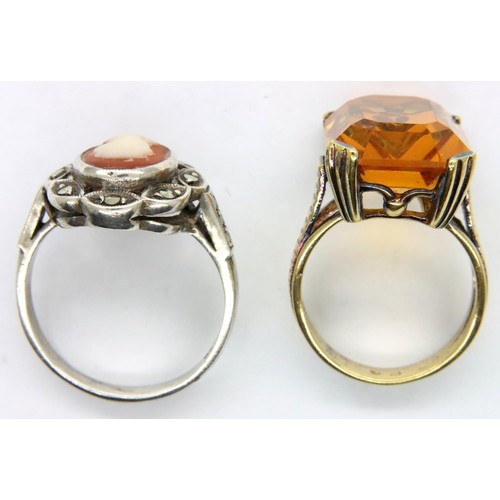 38 - A silver marcasite cameo ring and a yellow metal amber stone costume ring. P&P Group 1 (£14+VAT for ... 