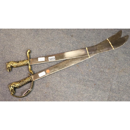 3233 - Pair of reproduction brass handled swords, blade L: 62 cm. Not available for in-house P&P, contact P... 