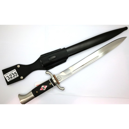 3235 - Hitler Youth, a good quality reproduction bayonet with scabbard, the chequered grip set with an enam... 