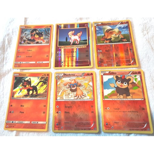 2130 - Collection of assorted Fire and Grass Pokemon trading cards including shiny / holographic examples; ... 