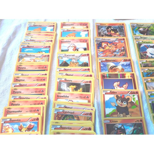 2130 - Collection of assorted Fire and Grass Pokemon trading cards including shiny / holographic examples; ... 