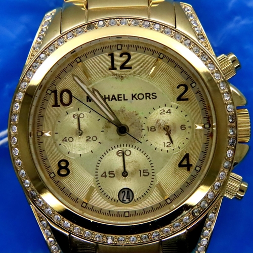 130 - Michael Kors; gents gold plated wristwatch with diamond style bezel, working at lotting. P&P Group 1... 