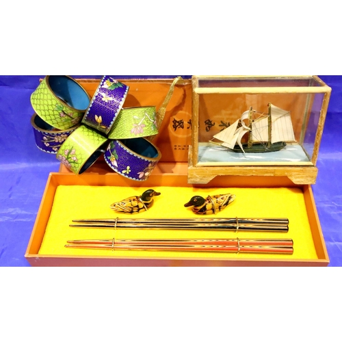 142 - Two sets of boxed chopsticks, a chopstick rest, six cloisonne napkin rings and a small glass cased s... 