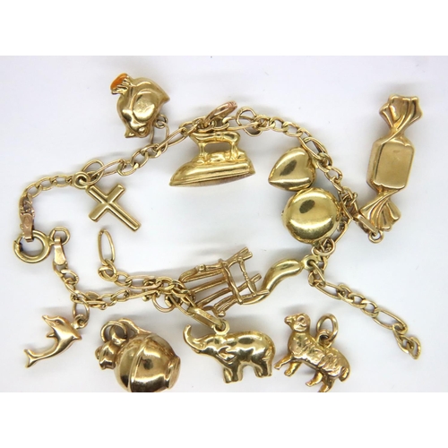 86 - 9ct gold charm bracelet with ten charms, 8.4g, chain broken. P&P Group 1 (£14+VAT for the first lot ... 