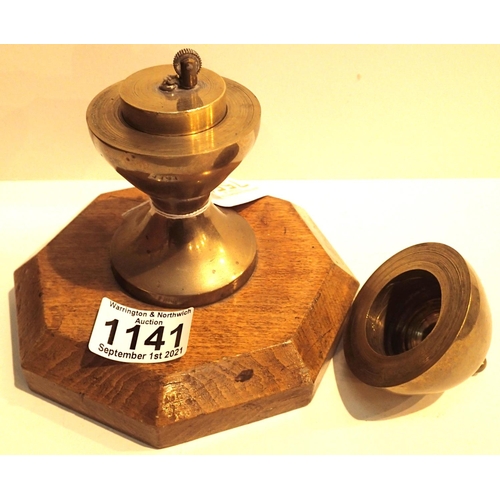 1141 - Antique trench art brass table gear lighter on octagonal mahogany base. P&P Group 2 (£18+VAT for the... 