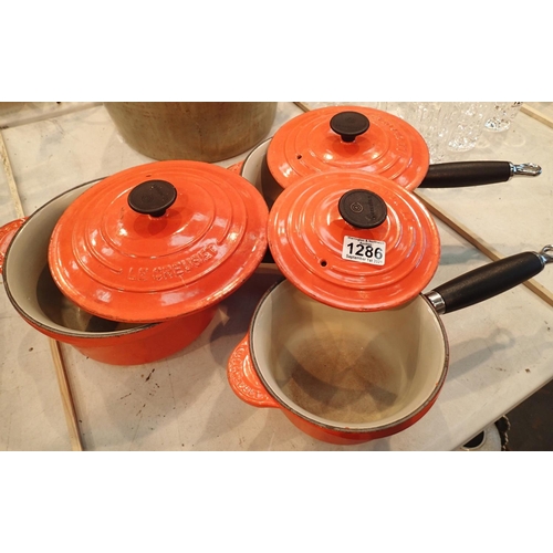 1286 - Set of three Le Creuset orange lidded saucepans. Not available for in-house P&P, contact Paul O'Hea ... 