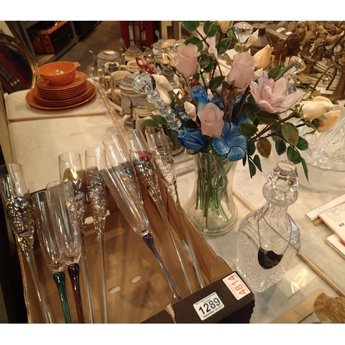 1289 - Mixed coloured champagne glasses, decanter and an artificial flower display. Not available for in-ho... 