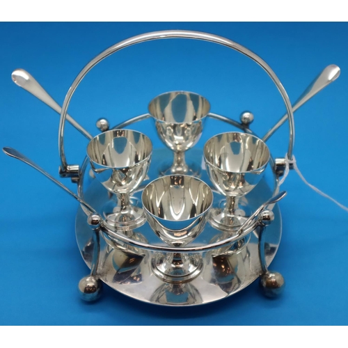 151 - Hallmarked silver Walker & Hall stand with four egg cups and spoons, Sheffield assay 1905, 655g. Mat... 