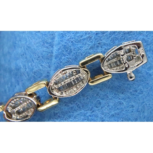 45 - 14ct white and yellow gold bracelet set with baguette cut diamonds, L: 18 cm, 18.4g. Good condition,... 