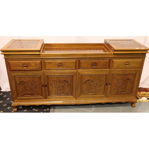 499 - An Oriental hardwood sideboard buffet, the cupboard doors with carved facias and folding top with in... 