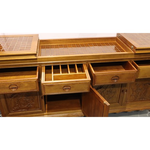 499 - An Oriental hardwood sideboard buffet, the cupboard doors with carved facias and folding top with in... 