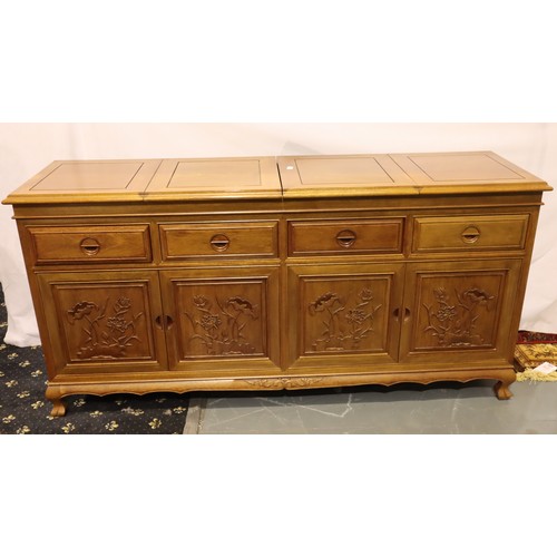 499 - An Oriental hardwood sideboard buffet, the cupboard doors with carved facias and folding top with in... 