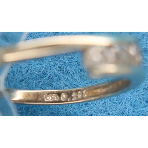 65 - 9ct white gold three stone (totalling 0.25cts) diamond crossover ring, size K, 1.8g. P&P Group 1 (£1... 