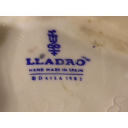 182 - Lladro figurine girl with posy, a further Lladro girl with a chamberstick and a Nao girl, H: 26 cm. ... 