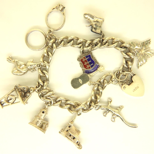 28 - 925 silver charm bracelet with ten charms, 43g. P&P Group 1 (£14+VAT for the first lot and £1+VAT fo... 