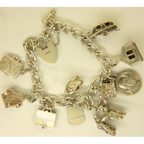 53 - Silver charm bracelet with ten charms and padlock clasp, 47g. P&P Group 1 (£14+VAT for the first lot... 