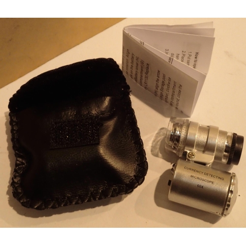 1129 - Leatherette cased 60x jewellery detaching loupe with LED. P&P Group 1 (£14+VAT for the first lot and... 