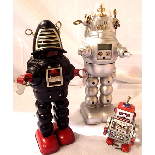 2067 - Three toy robots - Black sparking/walking, 23 cms, silver/red walking, 10 cms and silvery battered o... 