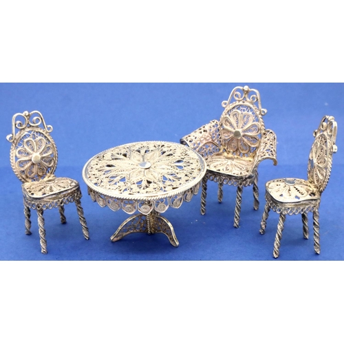 120 - Silver filigree miniature table and three chairs dolls house furniture. P&P Group 1 (£14+VAT for the... 