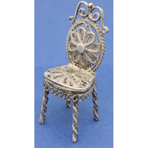 120 - Silver filigree miniature table and three chairs dolls house furniture. P&P Group 1 (£14+VAT for the... 