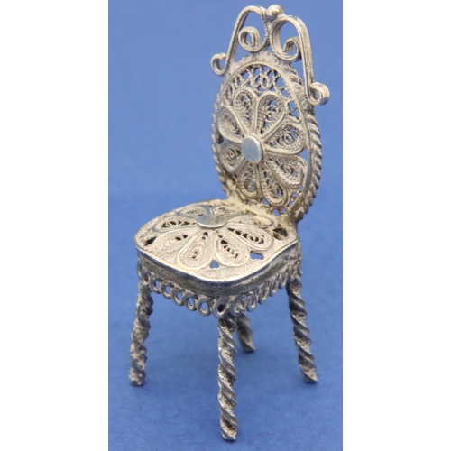 120 - Silver filigree miniature table and three chairs dolls house furniture. P&P Group 1 (£14+VAT for the... 