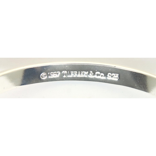 62 - 925 silver Tiffany and Co marked bangle, boxed, D: 60 mm, 27g. P&P Group 1 (£14+VAT for the first lo... 