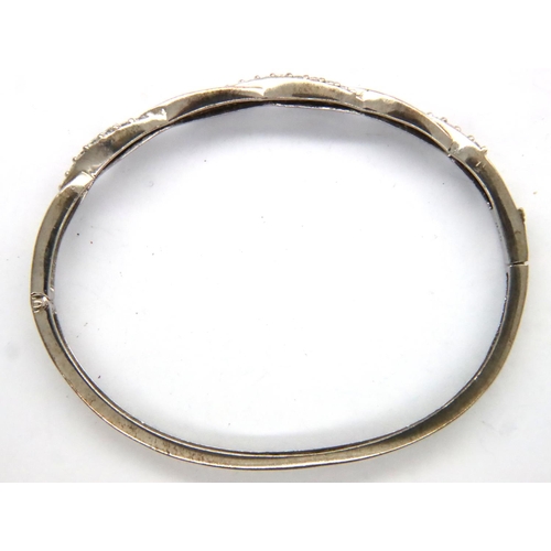 59 - 925 silver stone set hinged bangle, D: 55 mm, 9g, misshapen. P&P Group 1 (£14+VAT for the first lot ... 