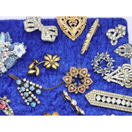 83 - Collection of thirty four assorted brooches, mounted to board. P&P Group 2 (£18+VAT for the first lo... 