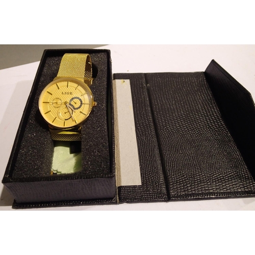 1090 - Lige; gents wristwatch with champagne dial, gold body and gold mesh strap, new in box, working at lo... 