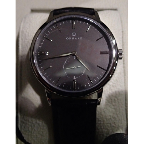 1101 - Ornake; new old stock stainless steel automatic wristwatch on a black leather strap, working at lott... 