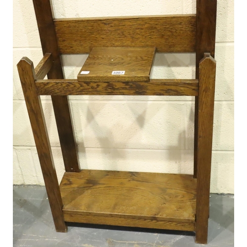 3067 - An early 20th century oak hall stand of simple construction with four hooks and incorporating a rect... 