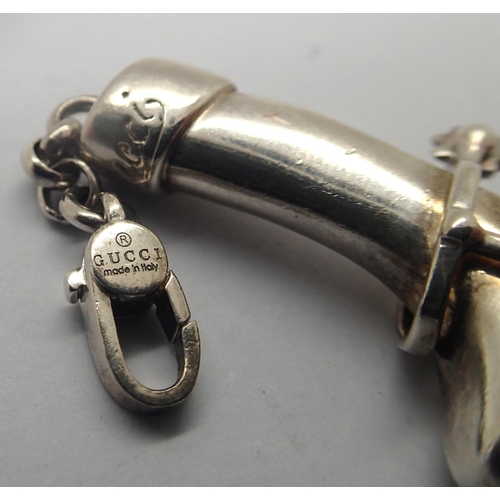 107 - Gucci silver bracelet in the form of riding boots and three further charms, L: 20 cm. P&P Group 1 (£... 