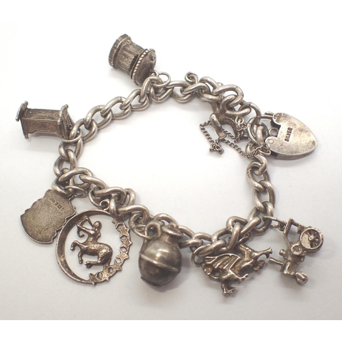 18 - 925 silver charm bracelet with eight charms to include tractor and dragon, L: 14 cm, combined 23g. P... 