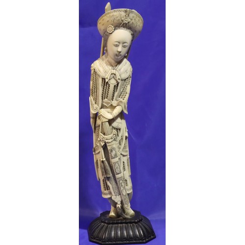 378 - Tall ivory figurine on wooden stand with pierced armour decoration carrying a spear and a quiver, H:... 