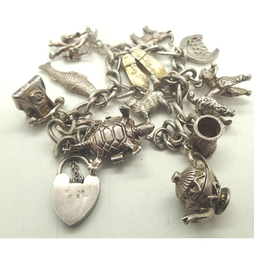 50a - 925 silver charm bracelet with twelve charms to include fish, poodle etc, L: 16 cm, combined 45g. P&... 