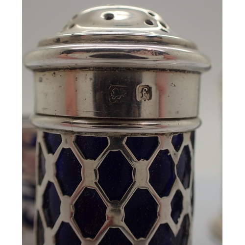 102A - Hallmarked silver salt and two pepperettes with blue glass liners. Not available for in-house P&P, c... 