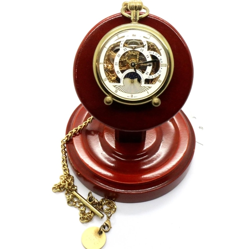 67 - Modern gold plated skeleton pocket watch with chain on a wooden stand. P&P Group 1 (£14+VAT for the ... 