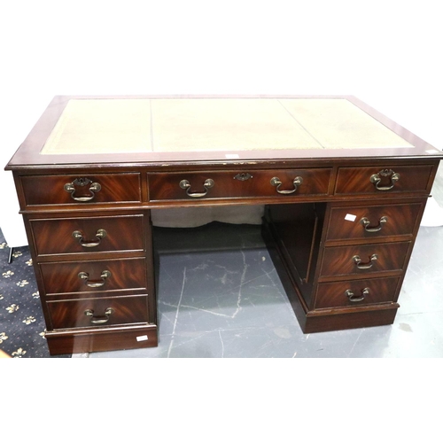 3105 - Reproduction mahogany twin pedestal writing desk having eight drawers and tooled green leather inset... 