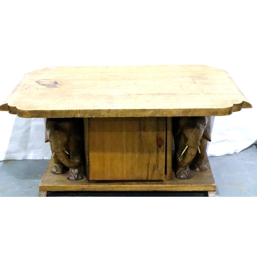 3111 - A 20th century carved fruitwood lamp/coffee table, shaped rectangular top supported by two carved el... 