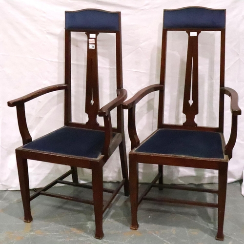 3128 - A pair of oak framed Arts and Crafts period elbow chairs, each with upholstered seat and headrest, e... 