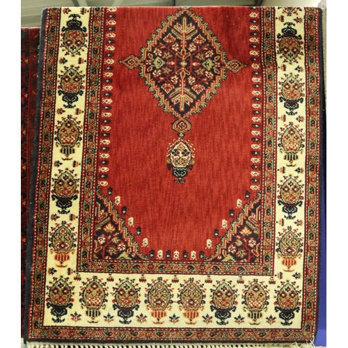 3065 - 20th century red ground rug, fringed, 200 x 100 cm. Not available for in-house P&P, contact Paul O'H... 