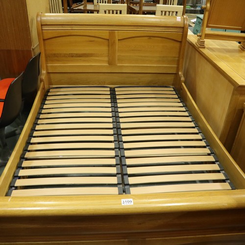 3109 - A substantial golden oak double sleigh bed frame, 215 x 150 x 110 cm H. May require further bolts. N... 