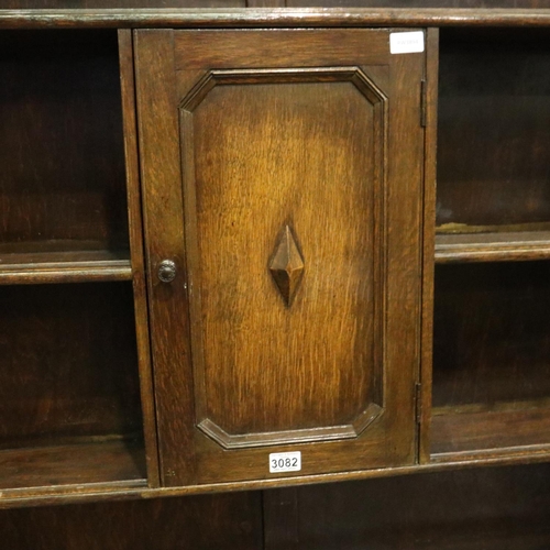 3082 - Early 20th century oak dresser, the slim plate rack with cupboard above sideboard base, 45 x 122 x 2... 