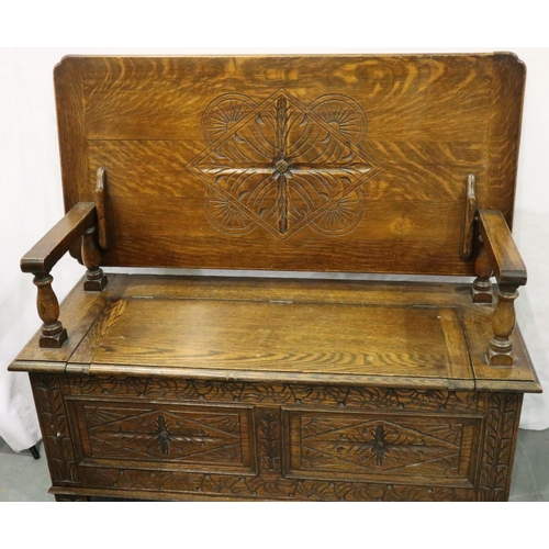 3084 - An early 20th century oak Monks bench with carved facias and panelled ends, 107 x 47 x 68 cm H. Not ... 