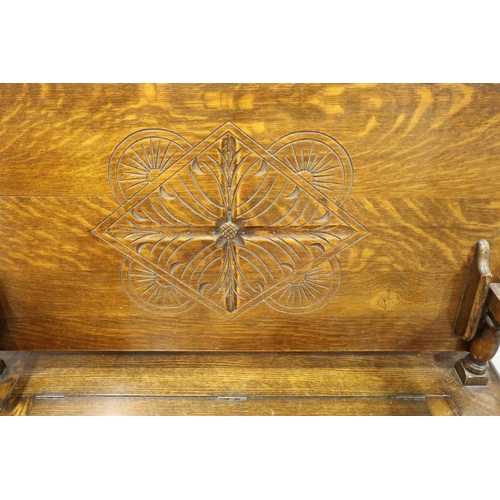 3084 - An early 20th century oak Monks bench with carved facias and panelled ends, 107 x 47 x 68 cm H. Not ... 