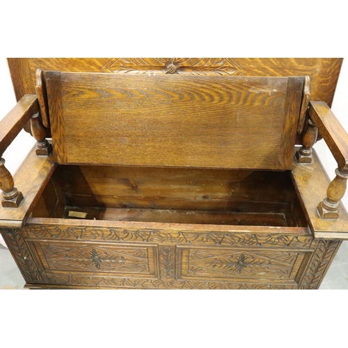 3084 - An early 20th century oak Monks bench with carved facias and panelled ends, 107 x 47 x 68 cm H. Not ... 