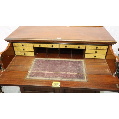 3092 - A Victorian mahogany secretaire, the fitted drawer with hinged writing surface above a two door cupb... 