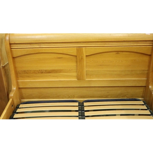 3109 - A substantial golden oak double sleigh bed frame, 215 x 150 x 110 cm H. May require further bolts. N... 