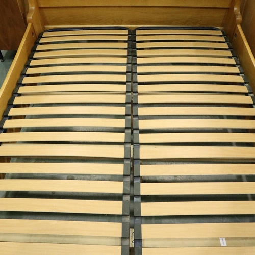 3109 - A substantial golden oak double sleigh bed frame, 215 x 150 x 110 cm H. May require further bolts. N... 