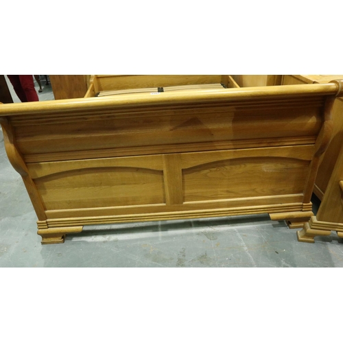 3109 - A substantial golden oak double sleigh bed frame, 215 x 150 x 110 cm H. May require further bolts. N... 